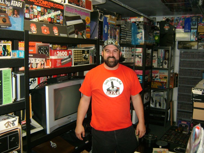John standing proudly in his game room, arguably the Mecca of gaming collections.