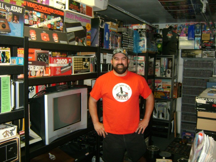 John Hancock strikes a pose with his collection. He keeps a CRT television plugged in to enjoy classic games.